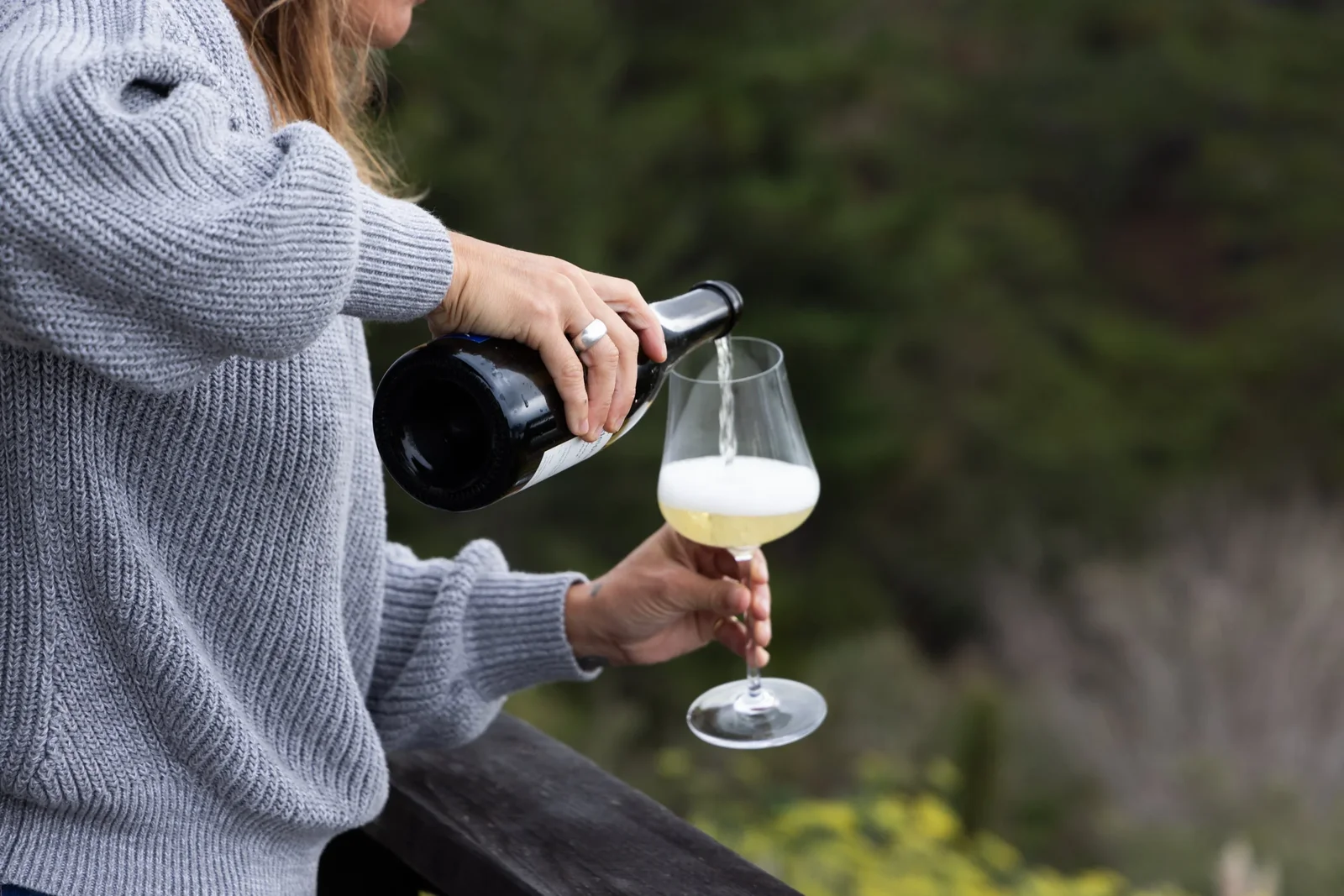 Expertly crafted sparkling wine being poured in coastal setting