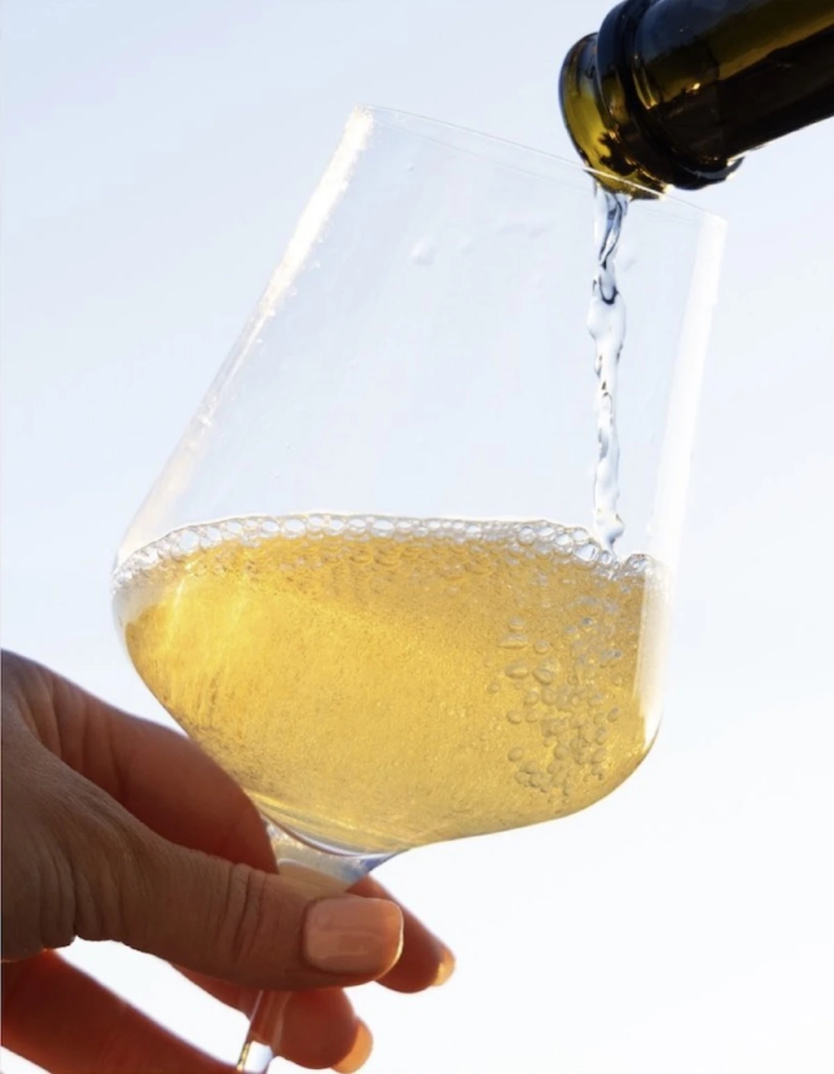 Golden California Crémant sparkling wine being poured into glass