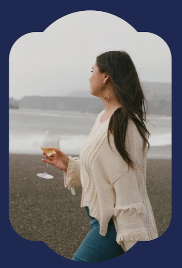 Woman enjoying sparkling wine on the beach
